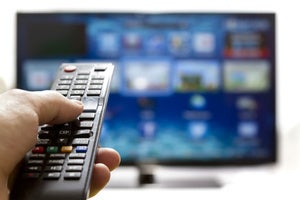 tv with hand on remote stock